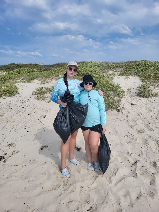 Teens picking up litter at the beach
