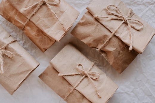 holiday gift wrapped in a reused brown paper bag