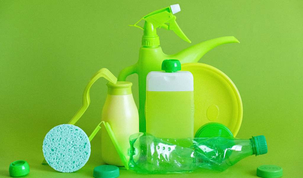 Green plastic containers with various cleaning products.