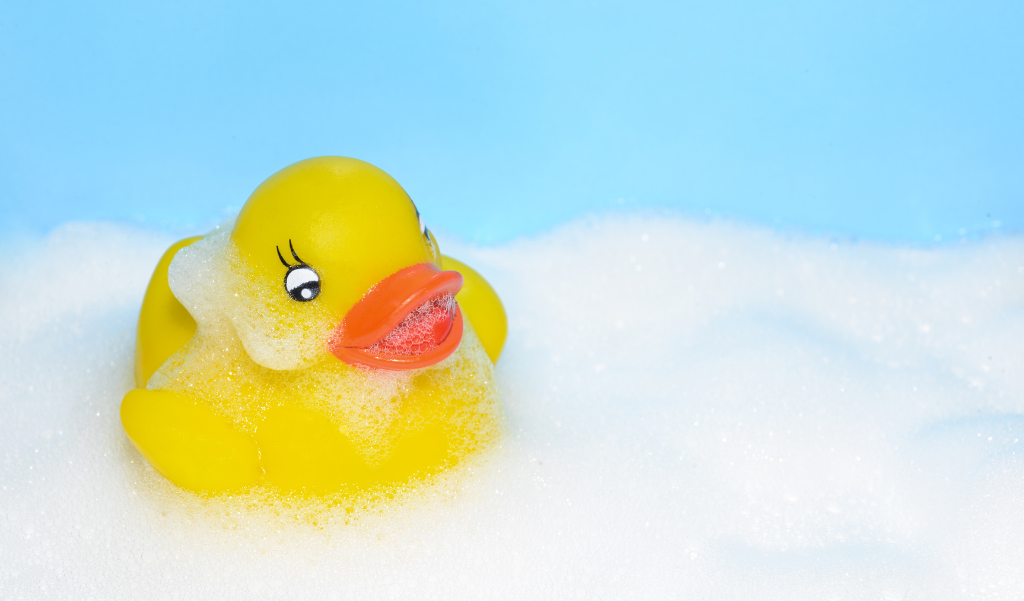 rubber duck in bath bubbles