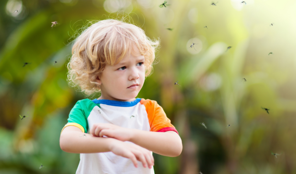 Child in the backyard surrounded by flying insects.