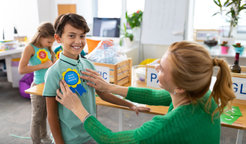 Student getting ribbon from teacher