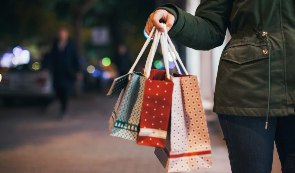 person carrying holiday shopping bags.