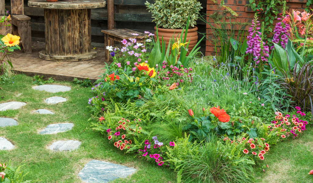 lush garden with flowers, green grass and stone path 