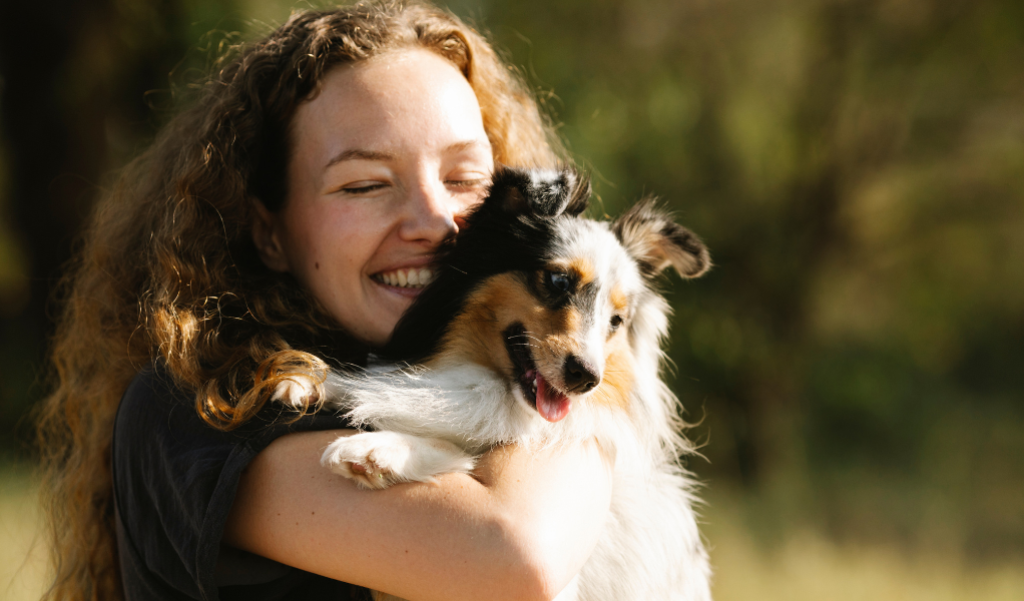 Woman hugging dog.