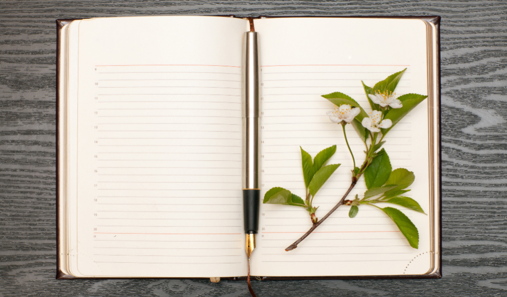 Diary with a pen and flower on top