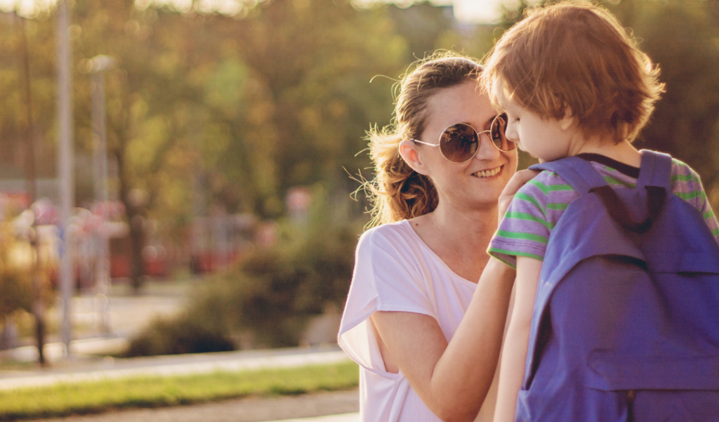 a mom prepares her child for the first day of school 