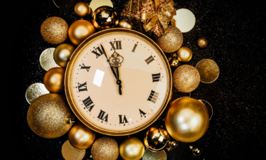 a clock surrounded by holiday decor