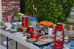used items for sale arranged on a table outdoors