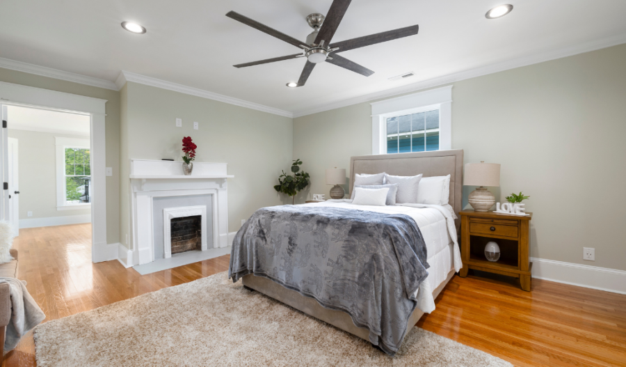 A bedroom with a ceiling fan.