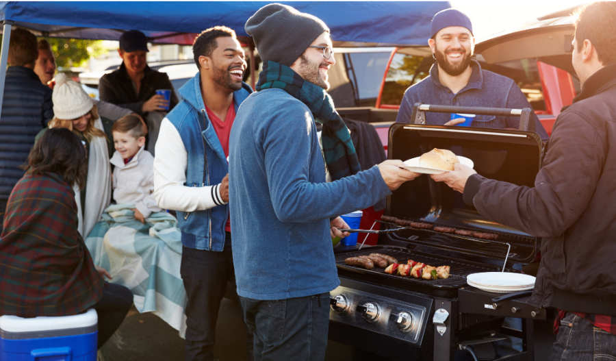 People grilling at a tailgate