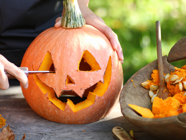 Person carving pumpkin.