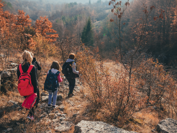 Family hiking in mountain during fall.