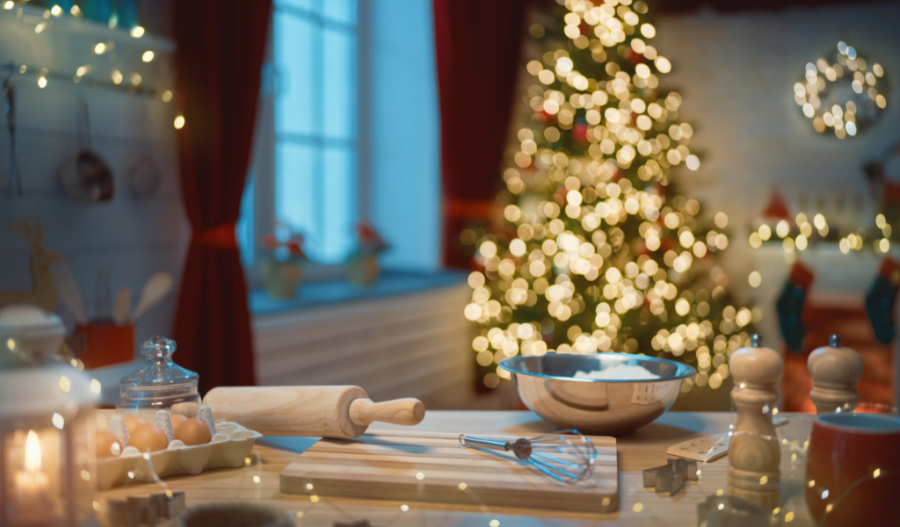 Baking material on a kitchen island in front of holiday decorations