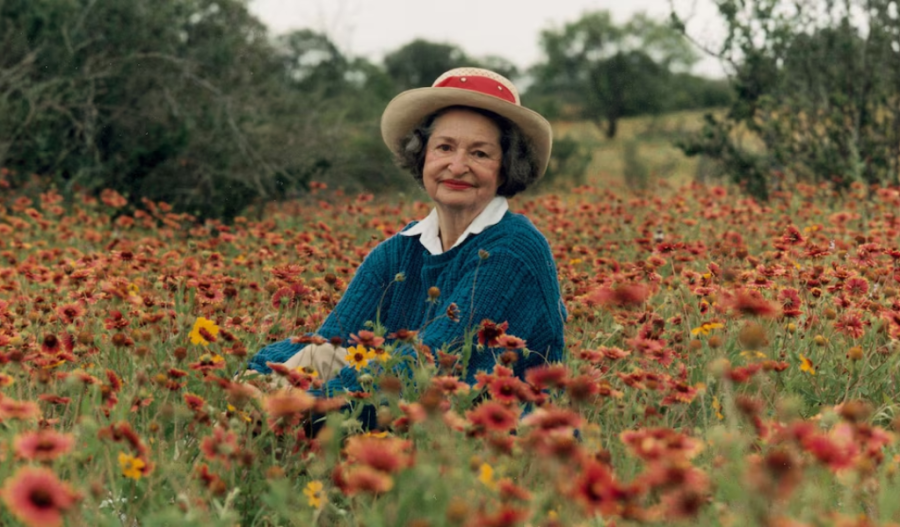 Claudia "Lady Bird" Johnson sitting in a field of wildflowers