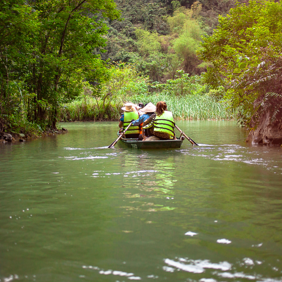 People traveling on a boat down a river.