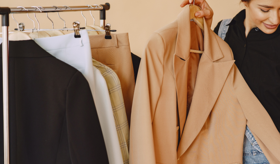 Woman holding a versatile piece of clothing a blazer