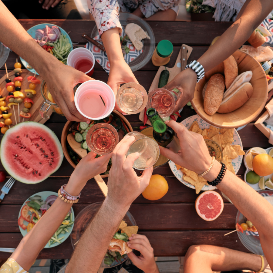 Toasting drinks with friends at a picnic 