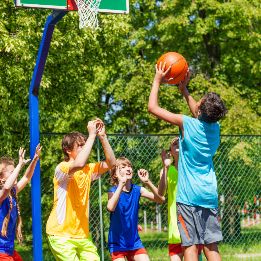 kids play basketball outdoors 