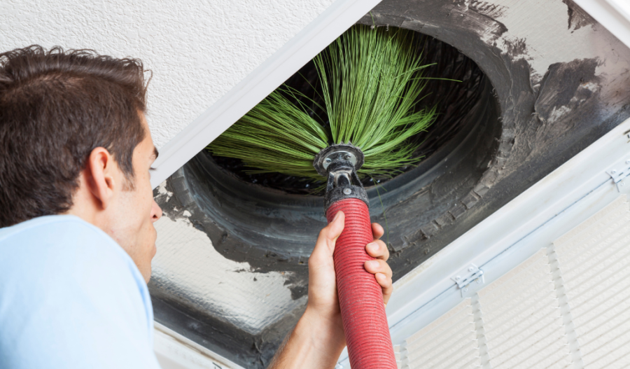 Someone cleaning air ducts