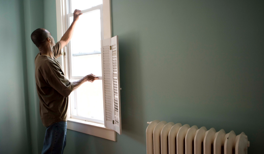 A man opening a window