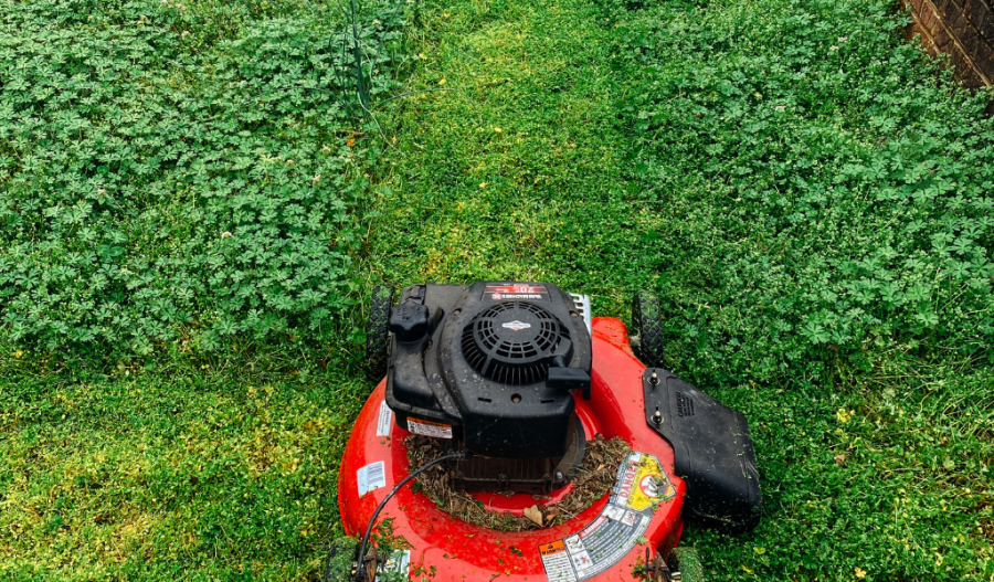 Lawnmower cutting parts of the yard.