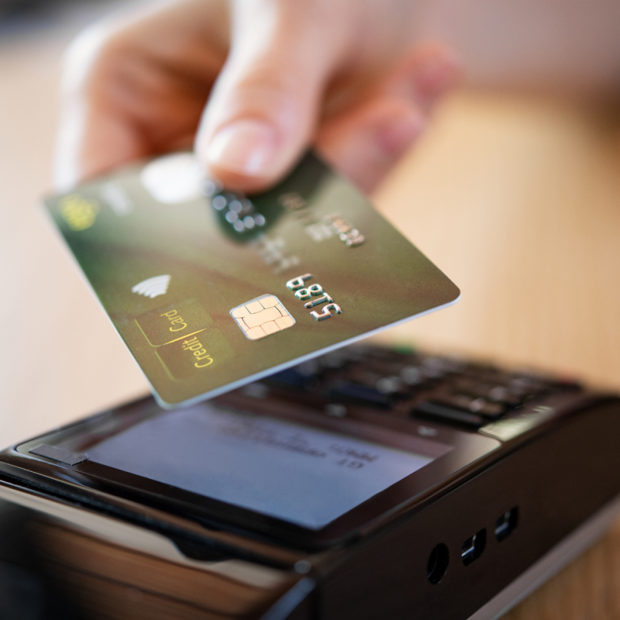 A person uses their credit card to purchase.