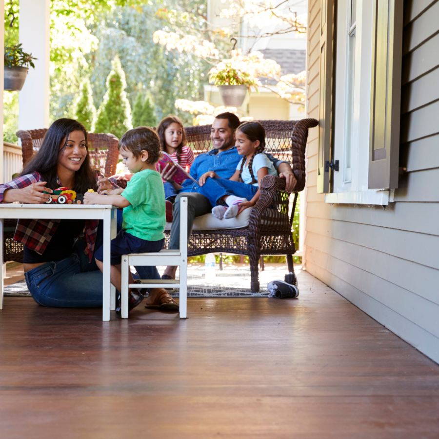 A family spends time on their front porch.