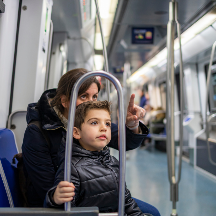 A mother and small son ride the subway. 