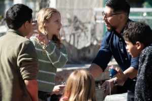 man talking to kids