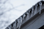 Icicles hanging from a roof.