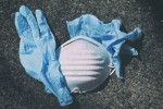 Littered gloves and mask on ground